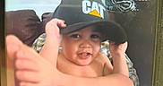 Learick Lee joined the competition — help win amazing prizes! adult, cap, casual, child, clothing, couch, face, foot, fun, hand, hat, home, indoor, person, playful, portrait, relaxed, sitting, smile, toddler