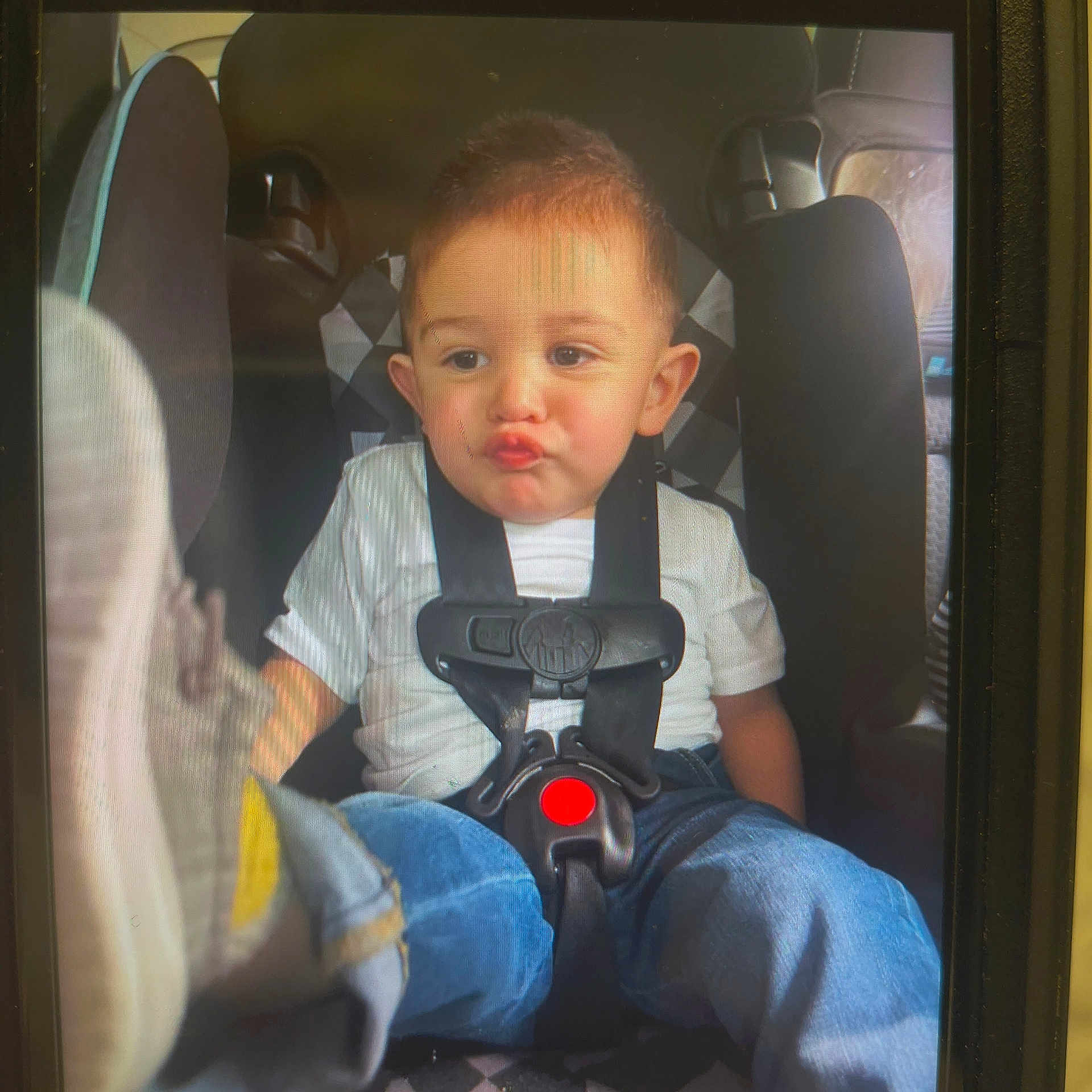 Learick Lee joined the competition — help win amazing prizes! baby, blue_jeans, car_interior, car_seat, casual_clothing, child, closeup, cute, indoor, person, portrait, pout, safety, seat, seatbelt, shoe, sitting, toddler, white_tshirt, young_child