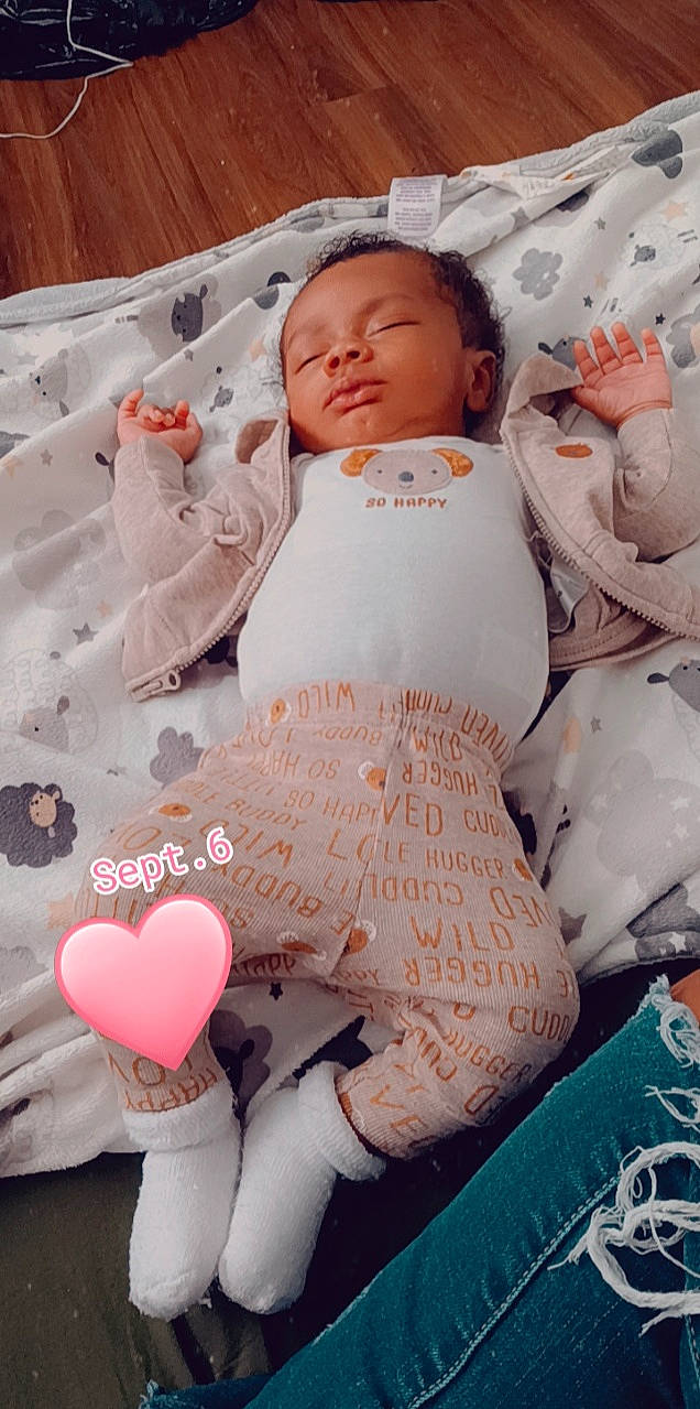 Benjamin Jr. is registered to the contest to win money with this photo: baby, baby_products, baby_sleeping, baby_toddler_clothing, bedding, carmine, cheek, child, comfort, face, head, linens, magenta, pattern, peach, person, pink, sleeve, thigh, toddler