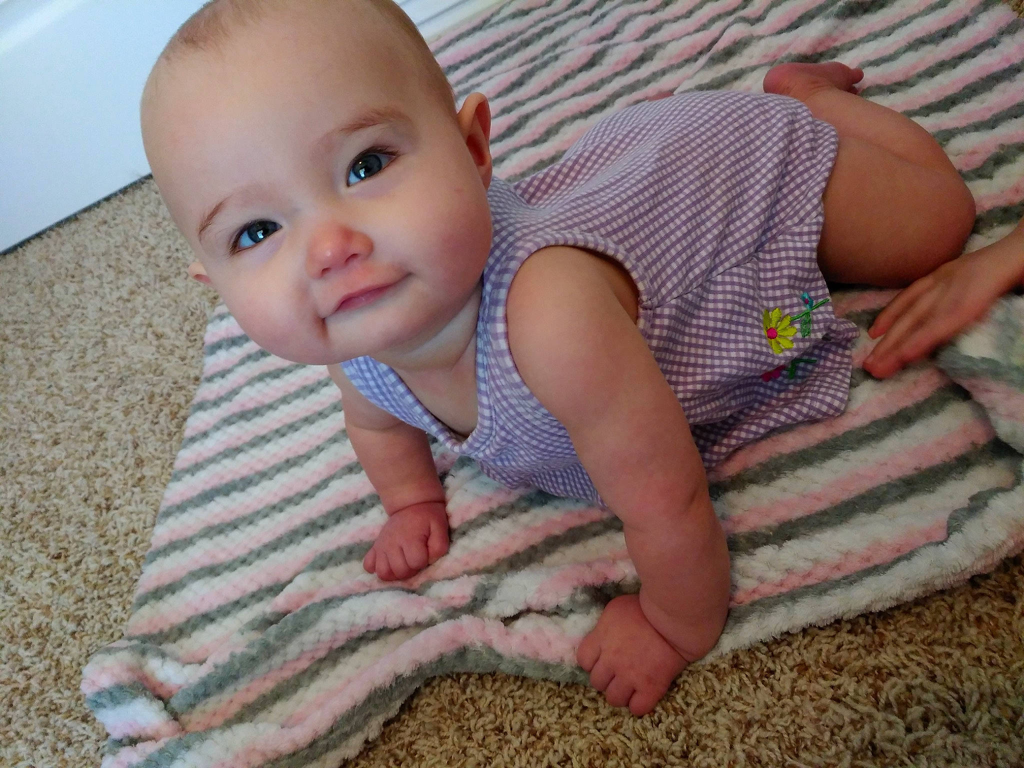 Nami is registered to the contest to win money with this photo: baby, baby_toddler_clothing, blanket, cheek, child, eye, face, head, linens, mouth, nose, person, skin, smile, textile, toddler, tummy_time