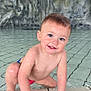 toddler, child, pool, water, wet, smiling, blue_eyes, skin, hand, face, hair, rock_wall, tiles, crawling, wristband, playful, outdoor, cute, young, person