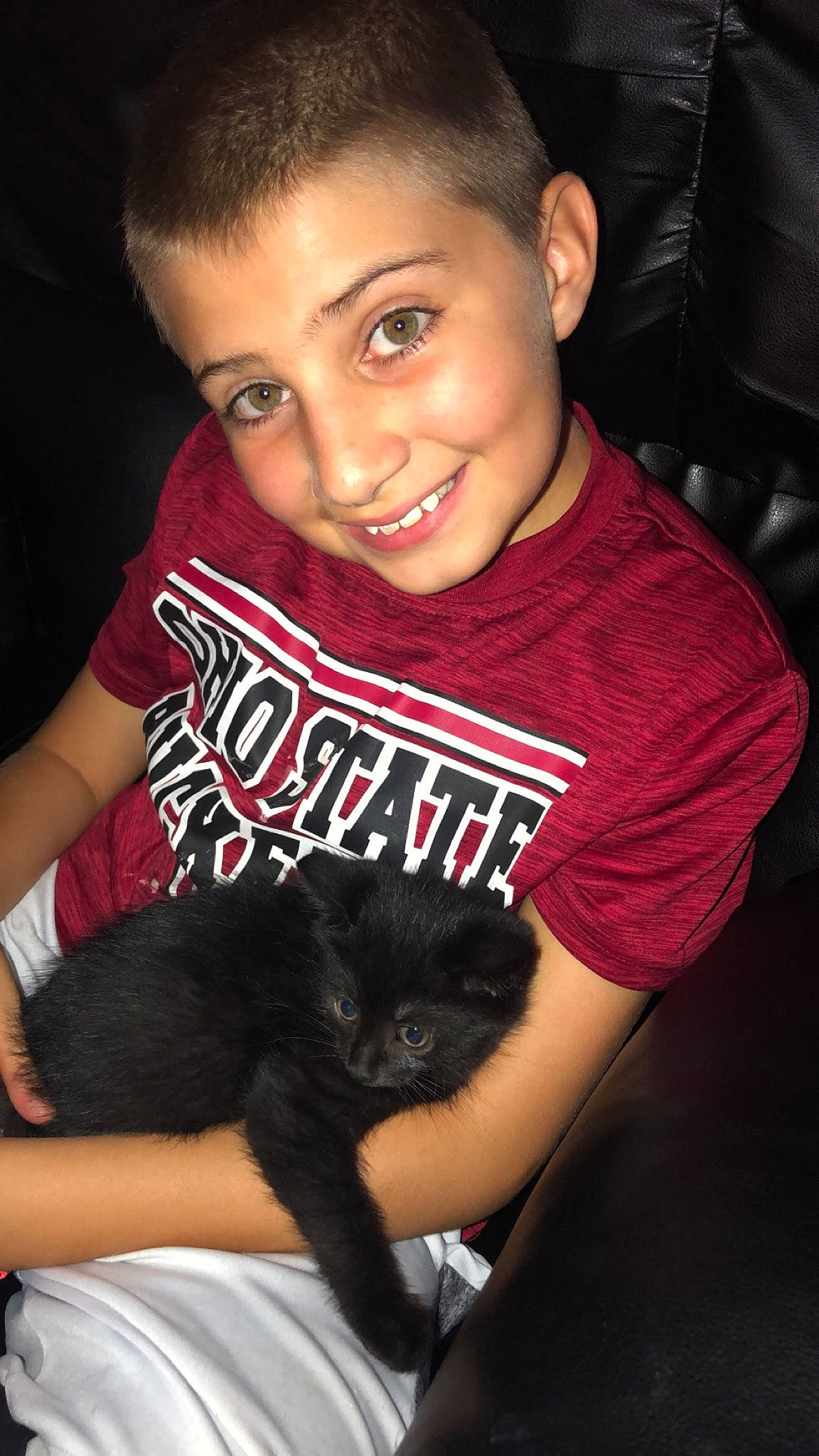 Austyn is registered to the contest to win money with this photo: black_hair, cheek, child, cool, ear, eyebrow, forehead, fur, hair, hairstyle, joy, long_hair, person, sitting, skin, smile, t_shirt, toddler