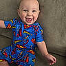 Zayden is registered to the contest to win money with this photo: baby, child, infant, smiling, happy, portrait, superman, superhero, costume, blue_clothing, couch, seated, indoors, face, eyes, open_mouth, short_hair, playful, close_up, photography