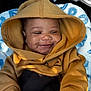 Alonzo is registered to the contest to win money with this photo: baby, child, hoodie, smile, happy, infant, clothing, blanket, blue, mustard, cozy, cute, portrait, face, young, person, sitting, warm, soft, indoors