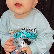 Ayoub participe au concours pour gagner de l'argent avec cette photo : baby, child, blue_eyes, mickey_mouse, sweatshirt, hand, face, stroller, seat, curious, clothing, person, infant, holding, casual, cute, portrait, sitting, indoor, young