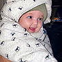 baby, child, smiling, blue_eyes, snowsuit, hood, knit_hat, warm_clothing, cute, face, portrait, infant, happy, wrapped, cozy, person, apparel, pattern, indoor, closeup
