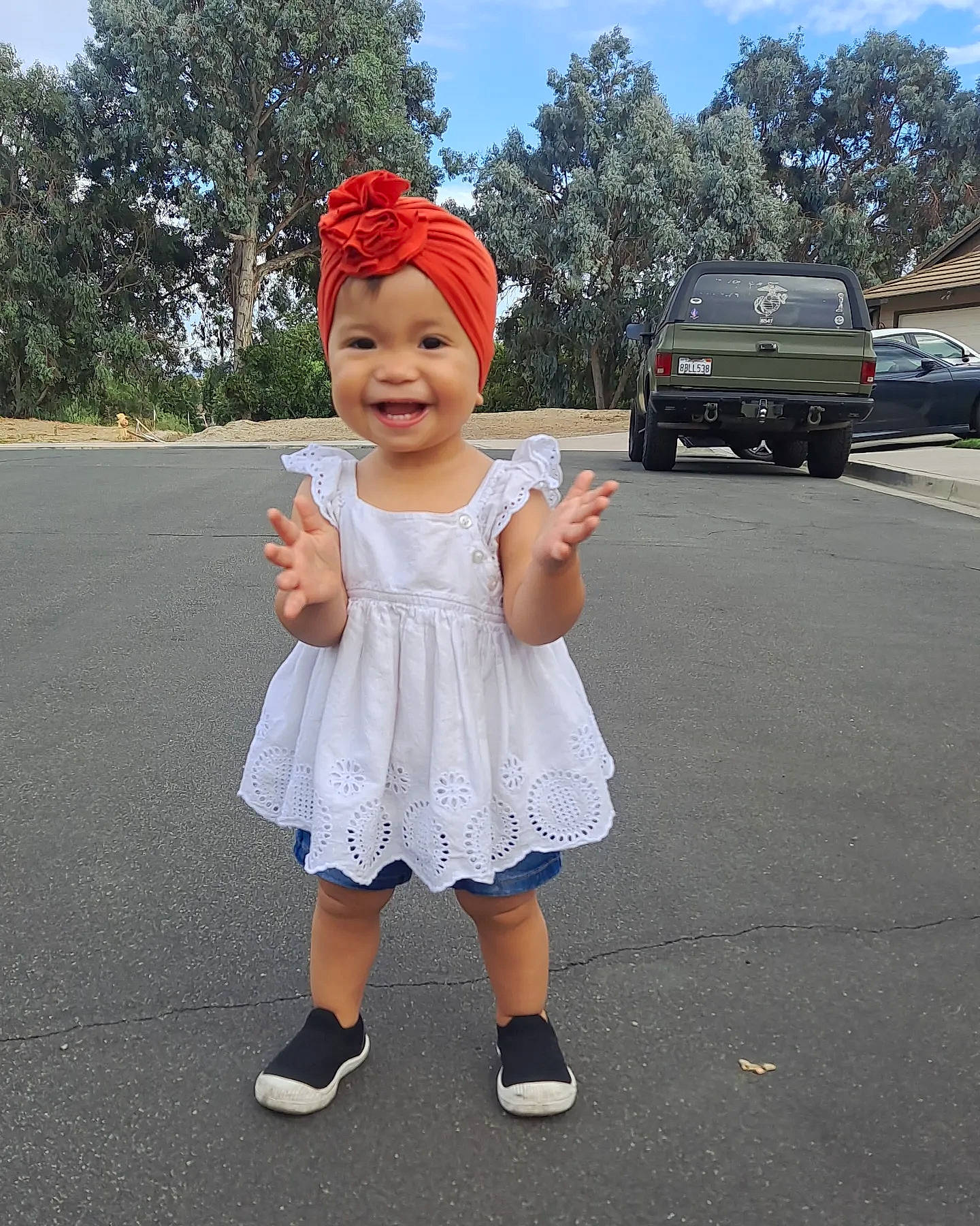 Anika joined the competition — help win amazing prizes! asphalt, baby_toddler_clothing, cap, car, electric_blue, footwear, fun, gesture, happy, hat, headgear, headwear, joy, leisure, person, recreation, sky, sleeve, smile, tire