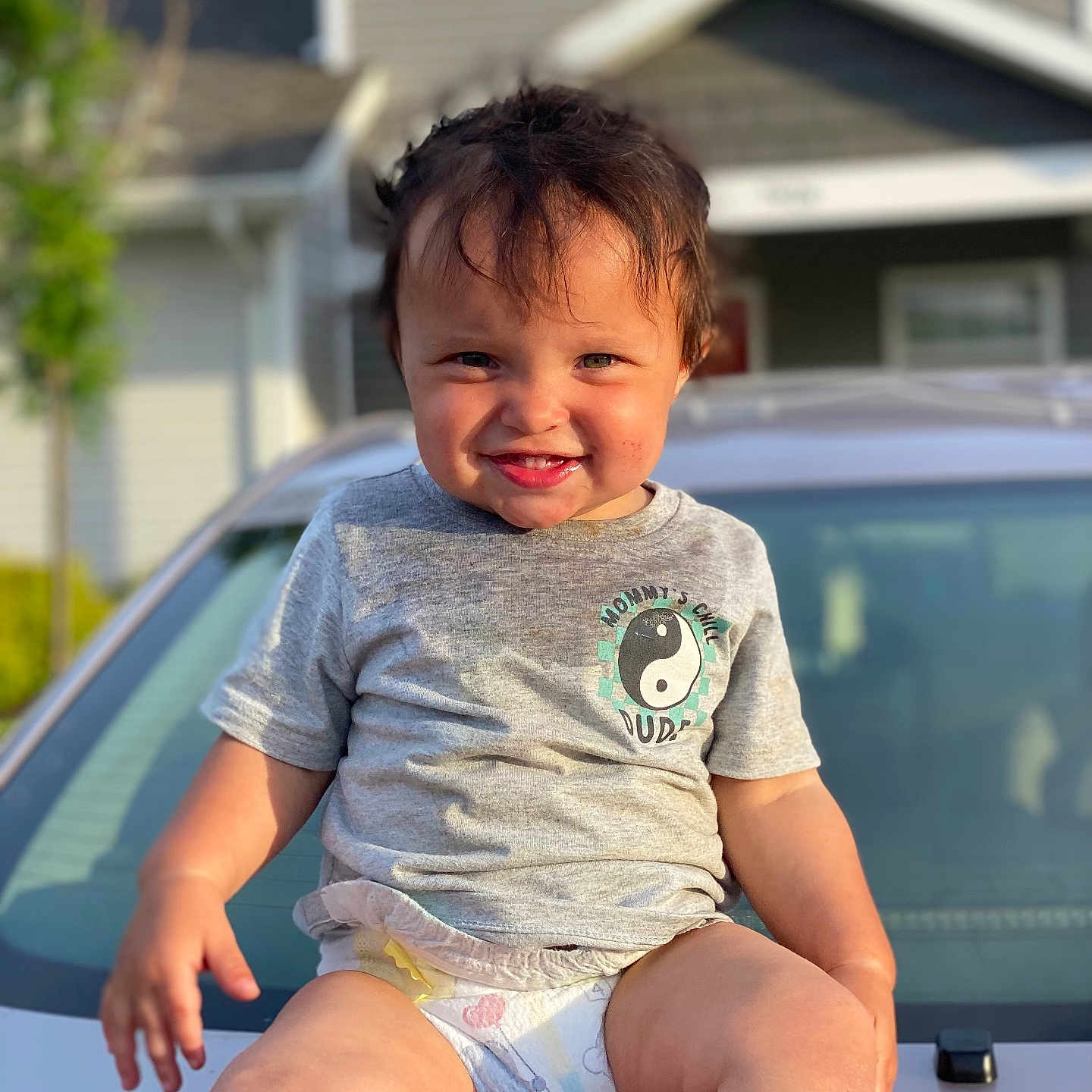 Carlito joined the competition — help win amazing prizes! baby, clothing, diaper, face, happy, head, neighborhood, outdoors, person, photography, plant, portrait, pottedplant, shorts, sitting, smile, summer, t_shirt, transportation, vehicle
