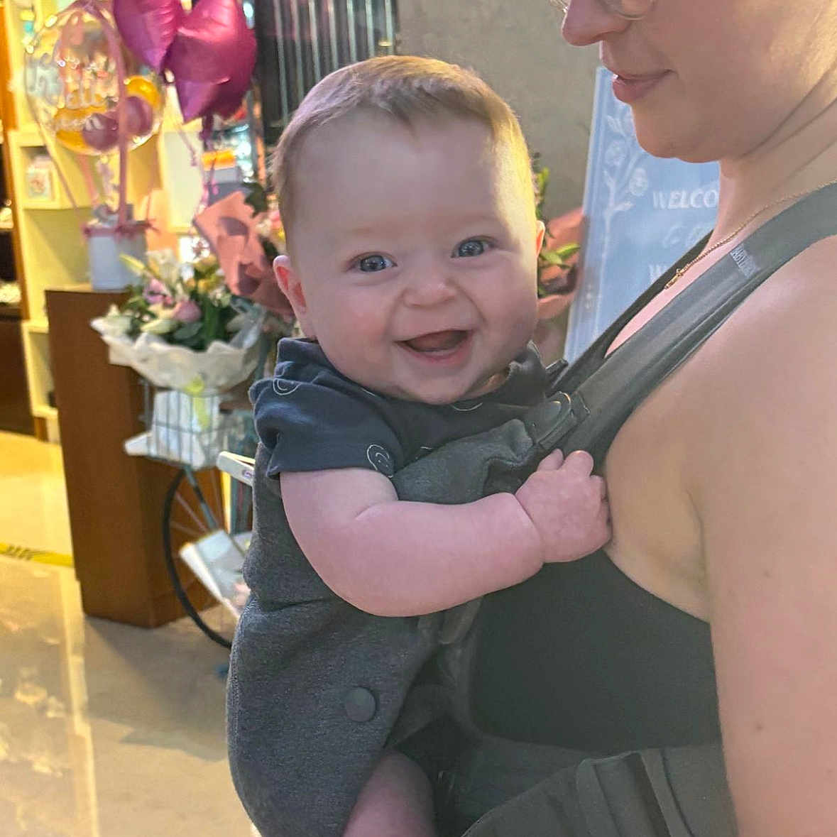 Noah is registered to the contest to win money with this photo: accessories, baby, babylaughing, balloon, clothing, coat, dress, face, flower, gun, happy, head, jewelry, necklace, person, photography, plant, portrait, pottedplant, weapon