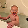 baby, babylaughing, bathing, bathtub, bodypart, face, finger, hand, happy, head, indoors, laughing, mouth, person, photography, portrait, sitting, smile, teeth, tub