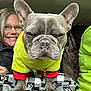 Gizmo Cepeck is registered to the contest to win money with this photo: dog, french_bulldog, pet, clothing, sweater, woman, smile, glasses, person, blanket, paw_prints, indoor, portrait, face, happy, cozy, seated, jacket, green, red
