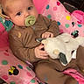 baby, pacifier, plush_toy, baby_chair, pink, polka_dots, stars, minnie_mouse, child, infant, seated, clothing, onesie, cute, indoor, portrait, looking_at_camera, comfort, toy, colorful
