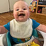 Ryder is registered to the contest to win money with this photo: baby, child, messy_face, bib, blue_shirt, baby_seat, toy, wooden_floor, indoor, happy, smiling, arms_outstretched, face, infant, seatbelt, colorful_toy, home, playful, young_child, closeup