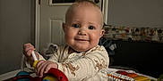 Ryder joined the competition — help win amazing prizes! baby, infant, smile, face, toy, activity_center, indoor, door, child, clothing, play, happy, cute, person, furniture, seat, colorful, hand, head, room