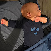 Ezio participe au concours pour gagner de l'argent avec cette photo : baby, bed, blanket, child, clothing, cute, face, hand, head, heart, indoors, infant, navy, pajamas, peaceful, person, resting, skin, sleeping, text