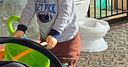 Matthew is registered to the contest to win money with this photo: baby, bucket, car_seat, carpet, child, childproof, clothing, door, floor, furniture, home, indoor, person, playing, safety_gate, smiling, toddler, toy, window, young