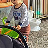 baby, bucket, car_seat, carpet, child, childproof, clothing, door, floor, furniture, home, indoor, person, playing, safety_gate, smiling, toddler, toy, window, young