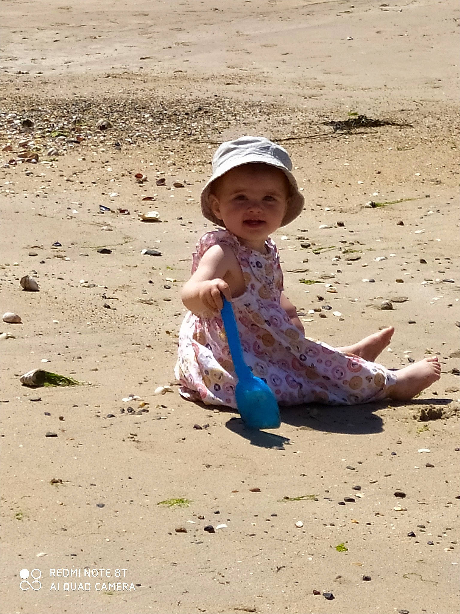 Mila participe au concours pour gagner de l'argent avec cette photo : ankle, baby, baby_toddler_clothing, barefoot, beach, building_material, child, foot, hat, headwear, people_in_nature, person, play, sand, slipper, soil, summer, sun_hat, toddler, toe