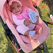 Hunter is registered to the contest to win money with this photo: alloywheel, baby, bonnet, cap, car, clothing, face, footwear, furniture, hat, head, hosiery, machine, person, photography, portrait, shoe, sock, stroller, wheel