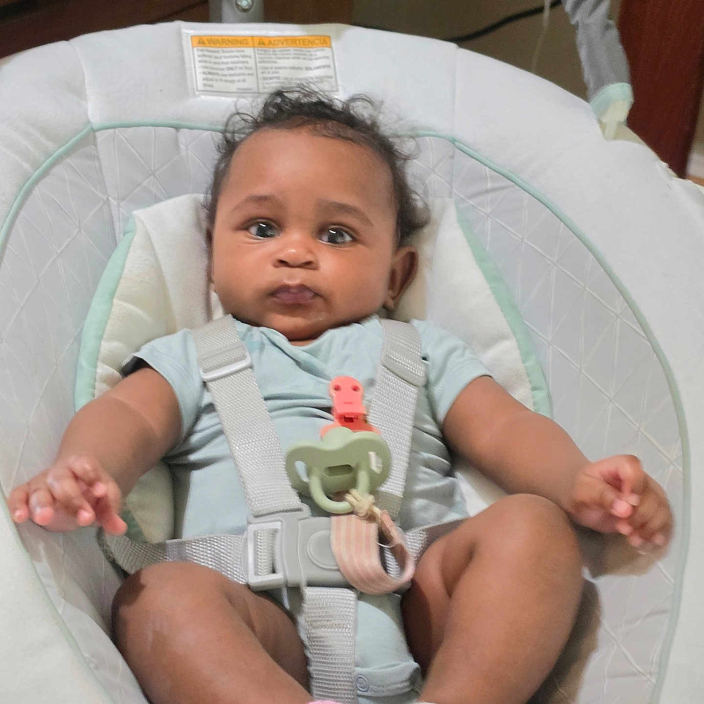Olivia joined the competition — help win amazing prizes! baby, infant, child, baby_seat, pacifier, clothing, onesie, socks, toy, harness, indoor, cushion, seat, cute, face, expression, person, skin, hair, comfort