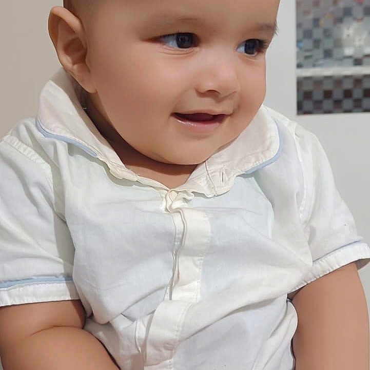 Abuzer joined the competition — help win amazing prizes! baby, biscuit, child, cute, eyes, face, furniture, hands, happy, head, indoor, infant, mouth, portrait, sitting, skin, smiling, striped_pants, white_shirt, young_child