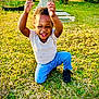 Ramaria is registered to the contest to win money with this photo: child, toddler, smiling, happy, outdoor, grass, tree, car, jeans, shirt, black_shoes, daylight, nature, playful, cute, portrait, person, sunlight, casual_clothing, kneeling