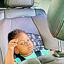 toddler, child, car_seat, blue_eyes, leather_seat, car_interior, seatbelt, young_child, baby, face, person, portrait, sitting, curious, infant, automobile, window, hair, clothing, seat