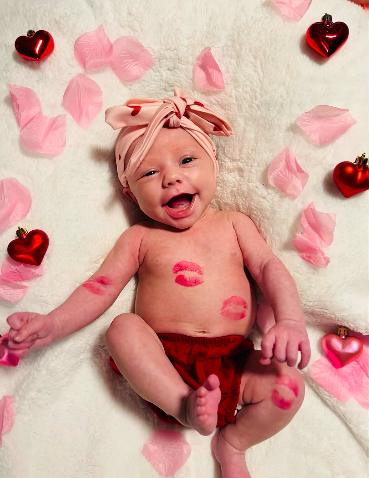 Hunter Grace is registered to the contest to win money with this photo: arm, baby_toddler_clothing, cheek, chest, face, foot, fun, gesture, happy, headwear, human_body, magenta, nail, person, pink, red, skin, smile, teddy_bear, thigh