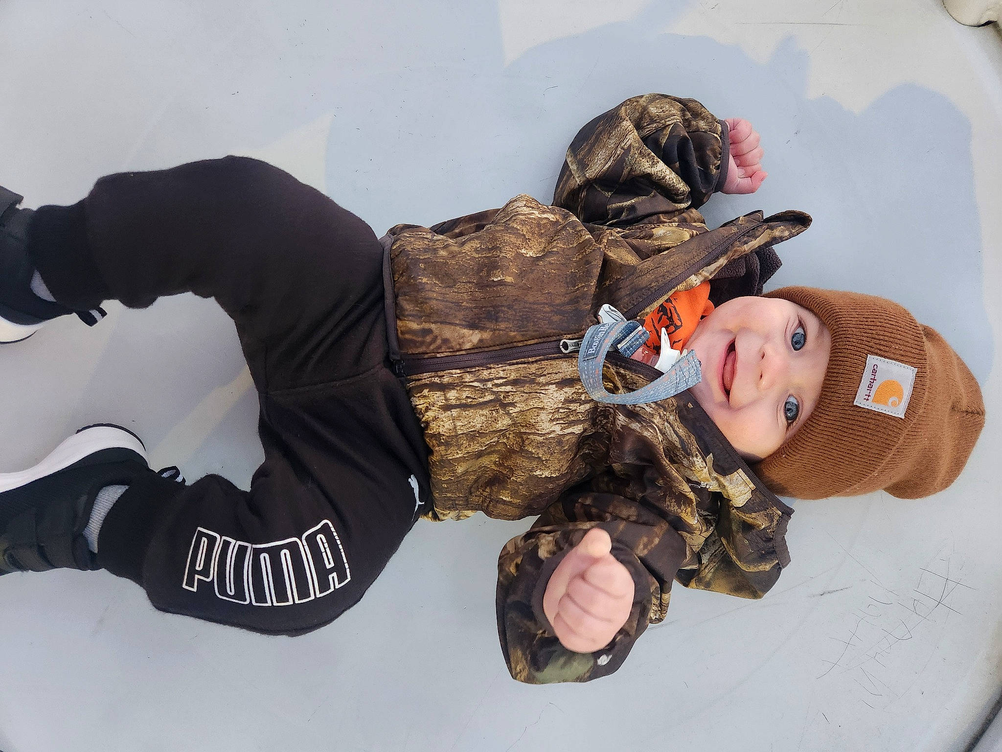Jayden is registered to the contest to win money with this photo: fun, fur, glove, hat, headgear, headwear, joy, knee, outerwear, person, personal_protective_equipment, sitting, sleeve, sock, stuffed_toy, toy, winter