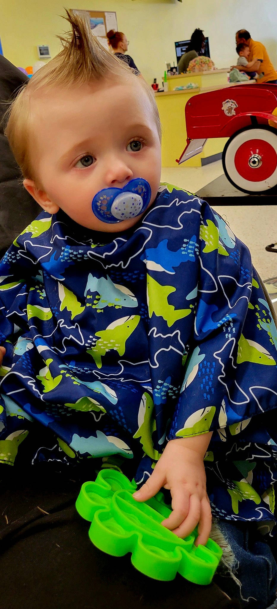 Nicolas is registered to the contest to win money with this photo: baby, baby_toddler_clothing, cheek, child, electric_blue, eye, face, fun, grass, green, head, iris, pattern, person, sleeve, t_shirt, tire, toddler, traffic_sign, wheel