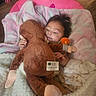 Zaira is registered to the contest to win money with this photo: baby, infant, child, stuffed_animal, monkey_toy, cuddling, sleepy, lying_down, blanket, pink, cozy, nursery, playroom, portrait, face, hands, plush_toy, indoor, wooden_floor, pacifier_clip