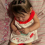 Zaira is registered to the contest to win money with this photo: baby, infant, child, sleeping, sitting, portrait, dress, watermelon, hair_bows, hair_ties, striped_bedding, bed, toy, beads, hands, arms, legs, earring, indoor, cute