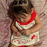 baby, infant, child, sleeping, sitting, portrait, dress, watermelon, hair_bows, hair_ties, striped_bedding, bed, toy, beads, hands, arms, legs, earring, indoor, cute
