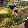 baby, barefoot, casual, child, clothing, daylight, foot, grass, green_chair, hand, nature, outdoor, park, people, person, picnic_table, relaxing, summer, sunlight, tree