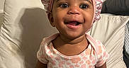 Valencia joined the competition — help win amazing prizes! baby, child, infant, smiling, happy, portrait, sitting, bed, pillow, bonnet, headwear, onesie, pink, floral, pacifier, indoors, bedroom, candid, face, safe