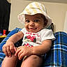 baby, child, infant, smiling, happy, portrait, hat, bucket_hat, striped_hat, minnie_mouse, shirt, clothing, sitting, indoor, home, blanket, blue_blanket, furniture, closeup, photography