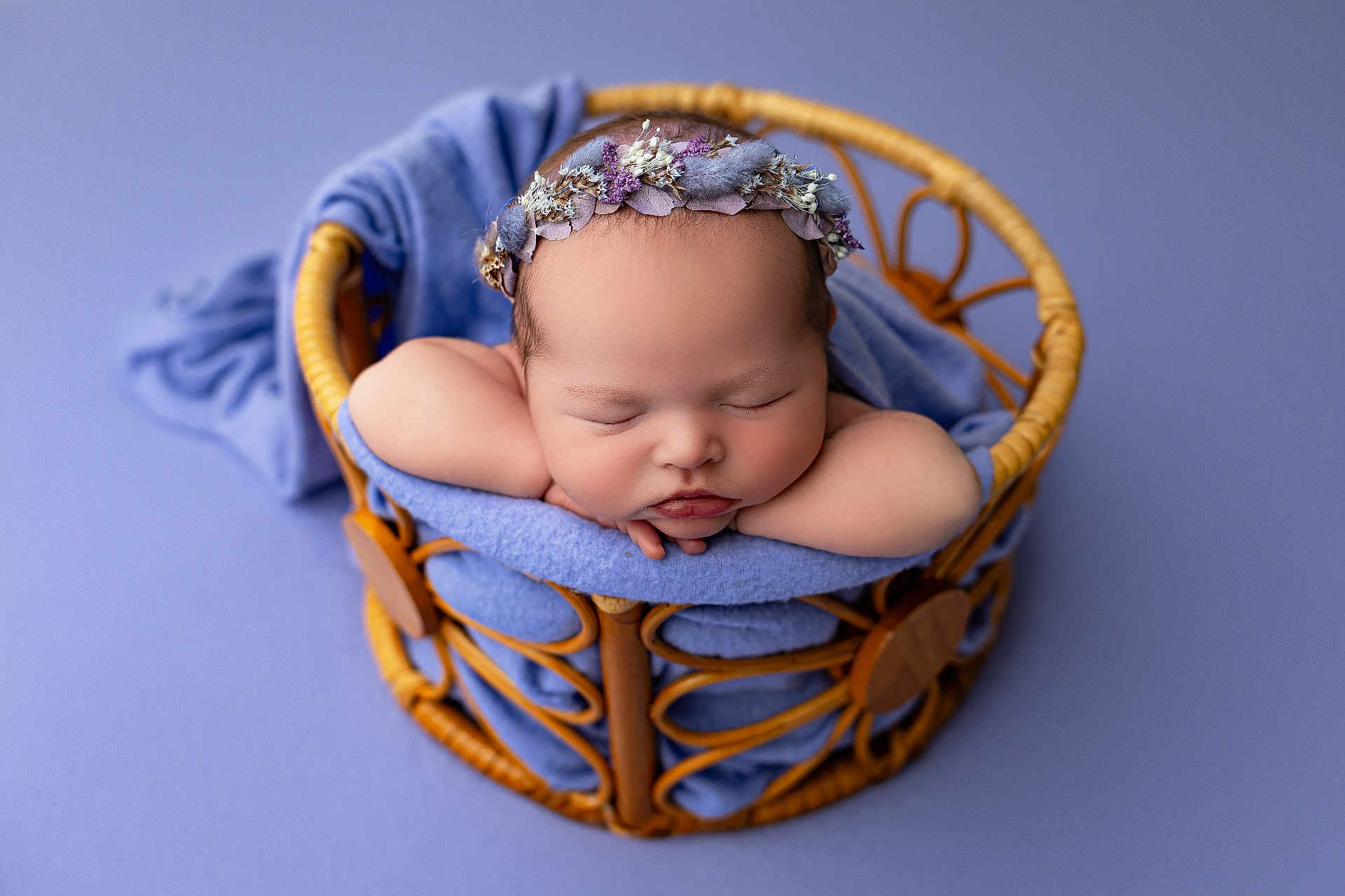 Evelyn is registered to the contest to win money with this photo: adorable, baby, blue_blanket, calm, child, closeup, cozy, cute, floral_headband, indoors, infant, newborn, peaceful, portrait, purple_background, resting, sleeping, soft_lighting, wicker_basket, wrapped