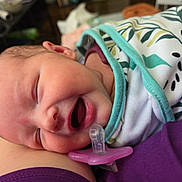 Evelyn is registered to the contest to win money with this photo: baby, blanket, child, closeup, clothing, cute, face, head, human, indoors, infant, mouth, newborn, pacifier, peaceful, portrait, resting, skin, sleeping, soft