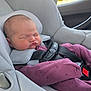 Evelyn is registered to the contest to win money with this photo: baby, car_interior, car_seat, child, clothing, cute, face, head, indoors, infant, newborn, peaceful, pink_outfit, portrait, resting, safety_harness, seatbelt, sleeping, transportation, young_child