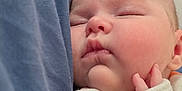 Evelyn joined the competition — help win amazing prizes! baby, blanket, closeup, clothing, cozy, cute, face, hand, infant, nap, newborn, orange, peaceful, portrait, rest, skin, sleeping, soft, toddler, white