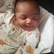 Malayna is registered to the contest to win money with this photo: baby, blanket, bodypart, bonnet, clothing, cushion, face, finger, hand, happy, hat, head, homedecor, knitwear, newborn, person, photography, portrait, sleeping, smile