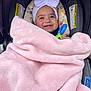 baby, blanket, headband, bow, stroller, smile, child, infant, pink, cozy, happy, toy, colorful, face, cute, clothing, comfort, portrait, seated, indoors