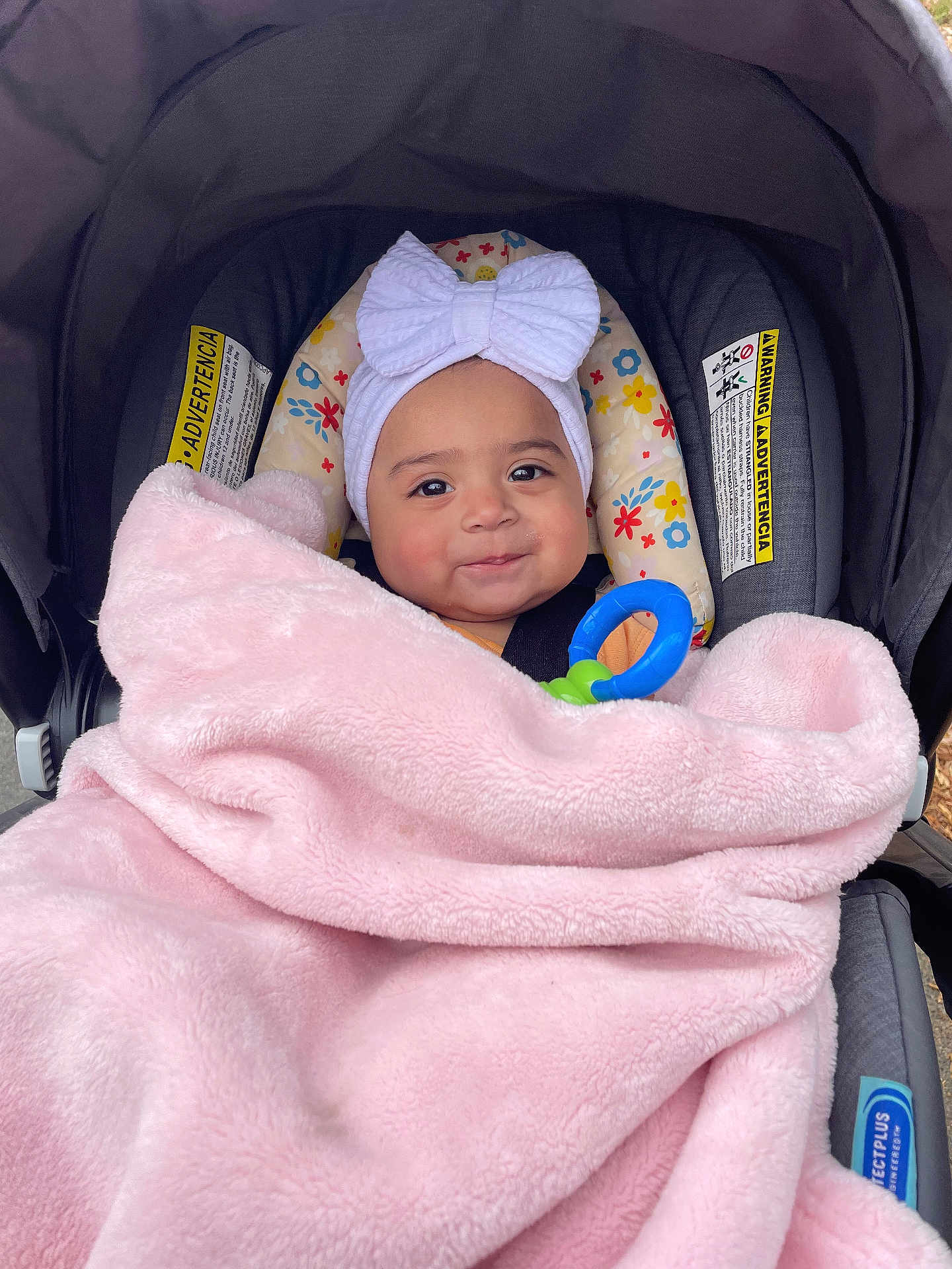 Averly joined the competition — help win amazing prizes! baby, child, blanket, car_seat, headband, bow, toy, smiling, face, infant, pink, soft, cozy, cute, indoor, portrait, person, clothing, closeup, happy