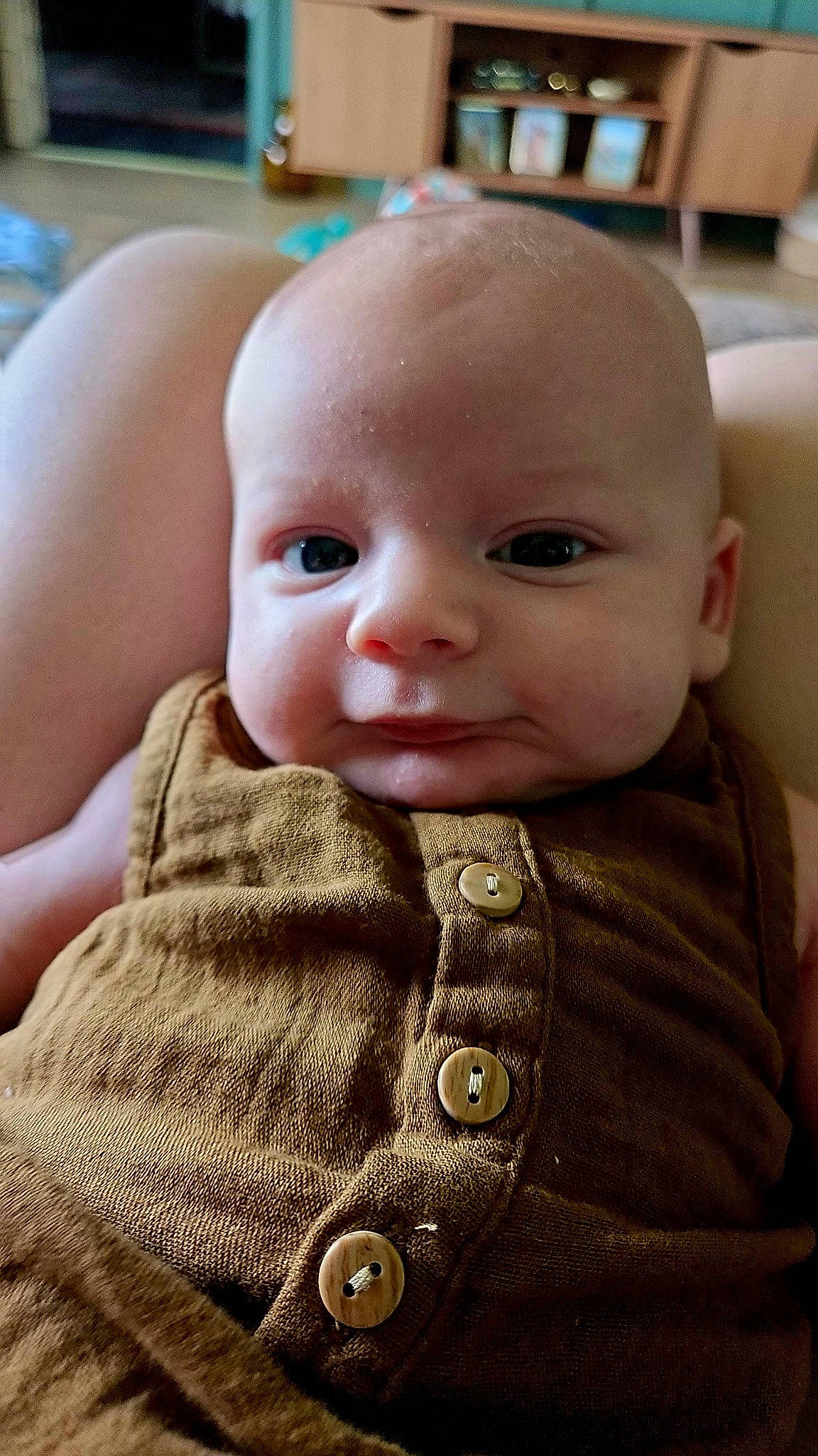 Ledger is registered to the contest to win money with this photo: baby, baby_toddler_clothing, cheek, child, chin, close_up, collar, comfort, eyebrow, eyelash, iris, lip, nose, person, sitting, skin, sleeve, toddler, wool, woolen