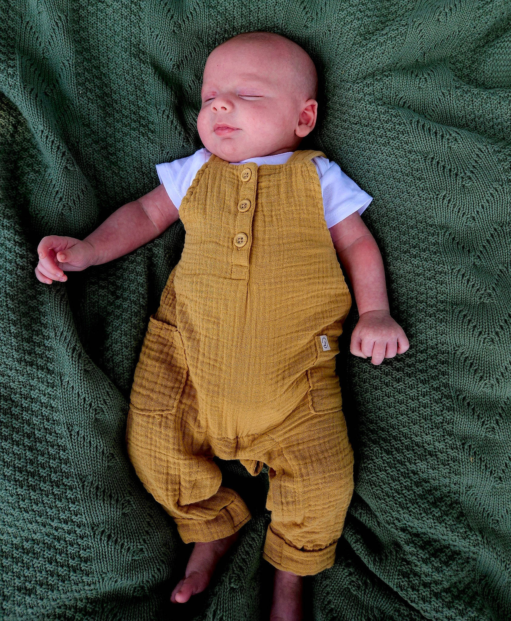 Ledger is registered to the contest to win money with this photo: baby, baby_products, baby_toddler_clothing, button, child, collar, comfort, flooring, knitting, linens, pattern, person, sandal, sitting, skin, sleeve, toddler, wood, wool, woolen