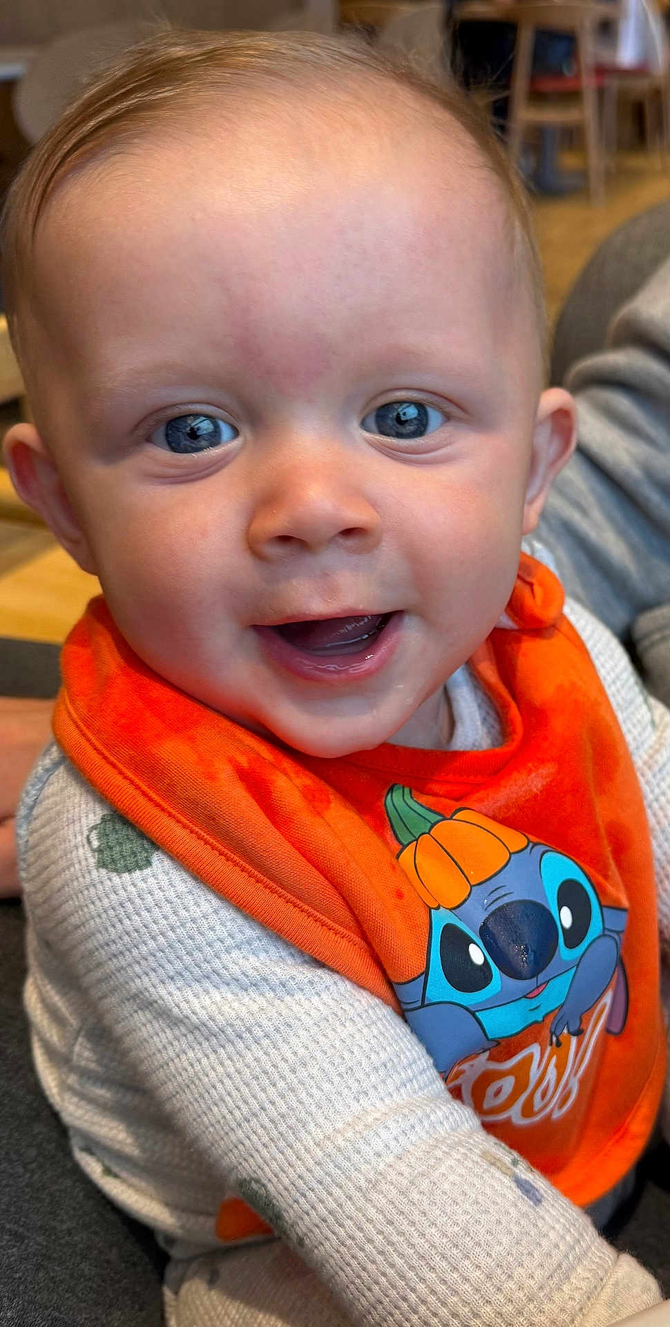 Finley is registered to the contest to win money with this photo: baby, child, smiling, blue_eyes, orange_bib, cartoon_character, pumpkin_hat, indoor, sweater, cute, happy, portrait, face, toddler, clothing, person, closeup, fun, holiday, infant