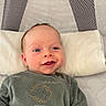 Logan participe au concours pour gagner de l'argent avec cette photo : baby, infant, smile, pillow, playpen, green_clothing, face, eyes, happy, lying_down, child, indoors, cute, newborn, soft_fabric, cozy, apparel, person, portrait, baby_clothes