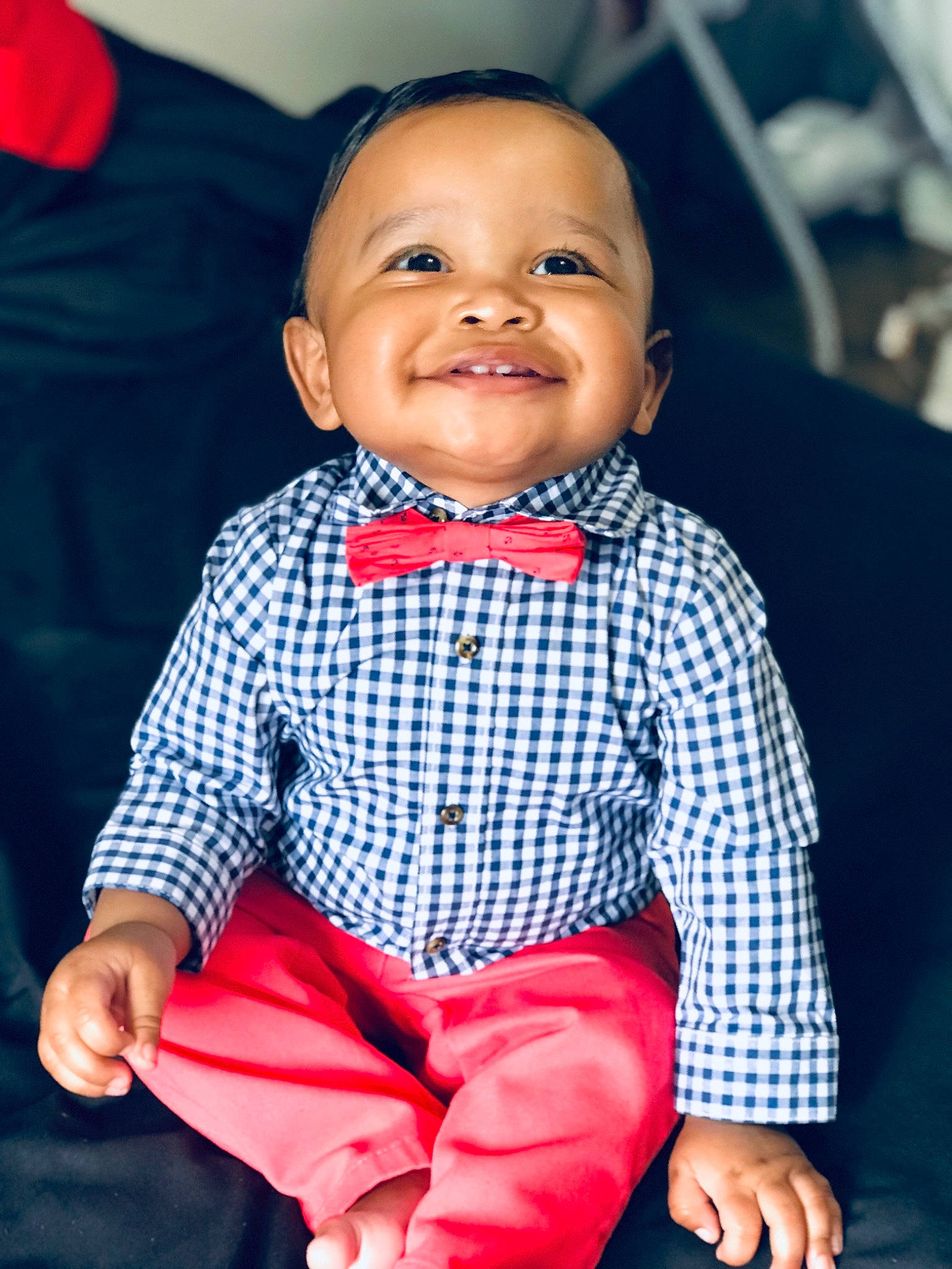 Cartier is registered to the contest to win money with this photo: baby, baby_products, baby_toddler_clothing, blue, bow_tie, cheek, child, chin, face, head, joy, lip, outerwear, person, pink, plaid, red, sitting, skin, smile