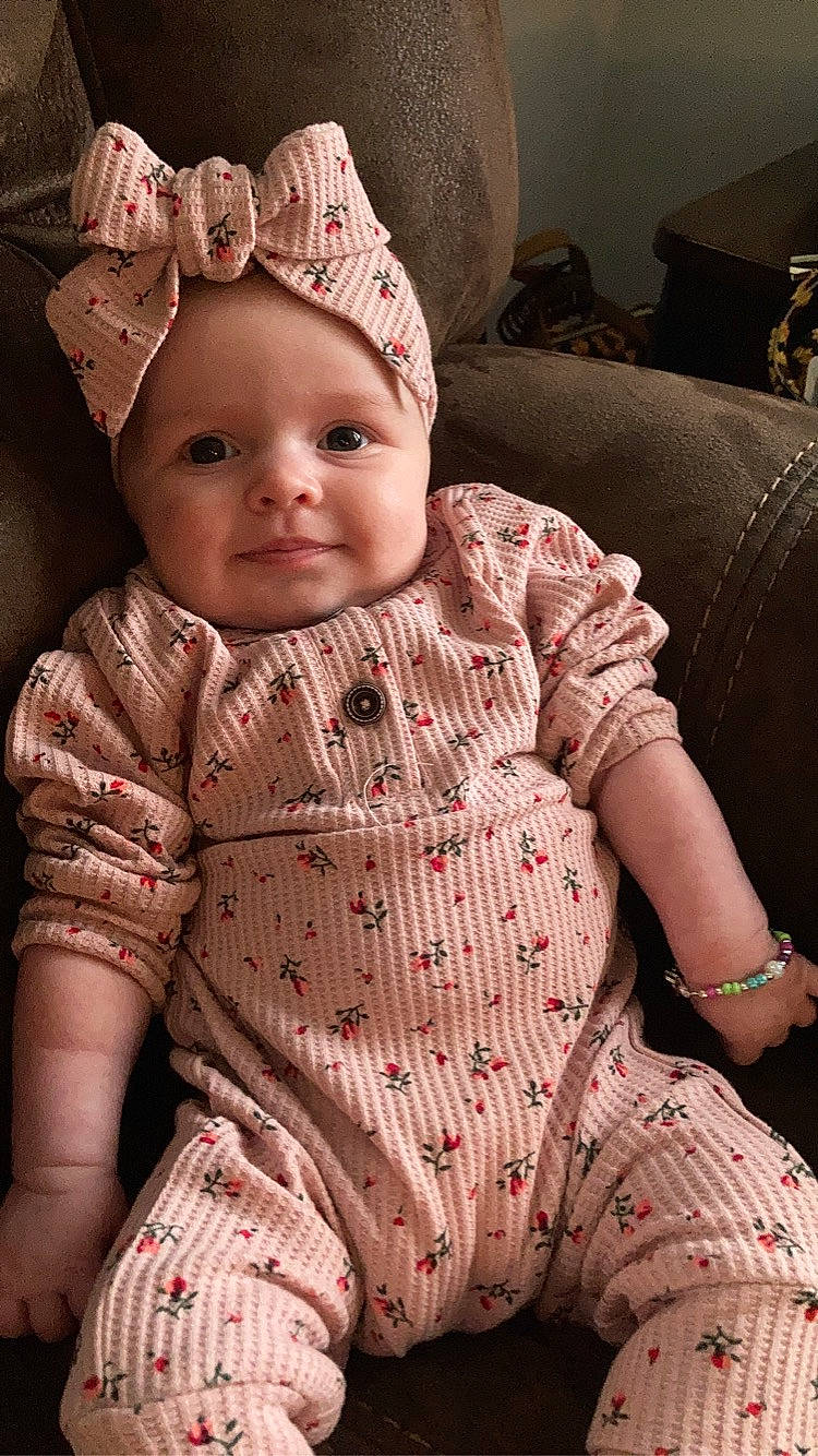 Abby is registered to the contest to win money with this photo: baby, baby_toddler_clothing, cap, cheek, child, costume_hat, dress, hat, headband, headwear, human_body, iris, jewellery, knit_cap, lip, outerwear, pattern, person, pink, skin
