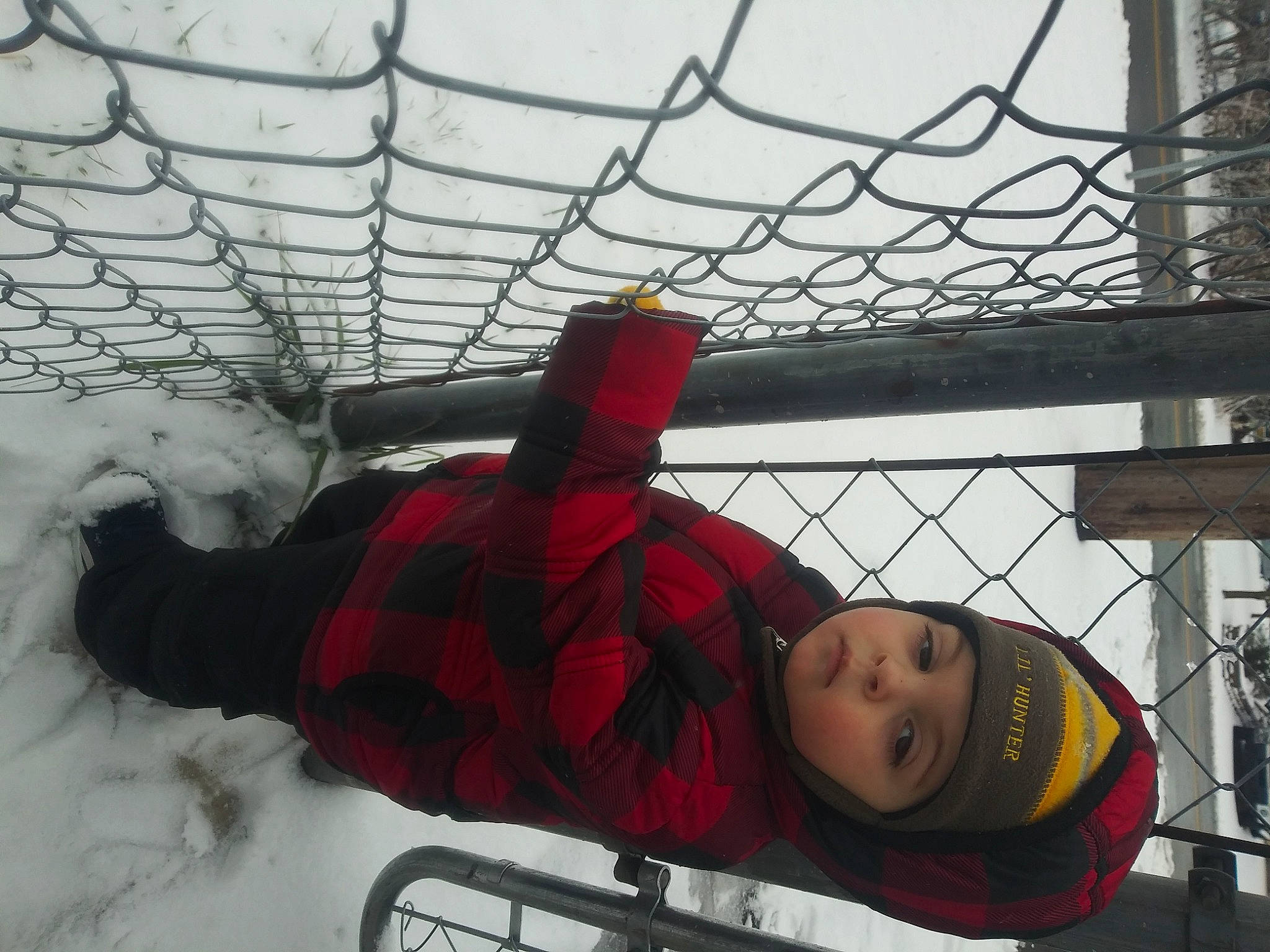 Jojo is registered to the contest to win money with this photo: black, carmine, ceiling, chain_link_fencing, freezing, fun, headwear, leisure, mesh, net, organ, pattern, person, recreation, red, snow, toddler, tower, tree, winter